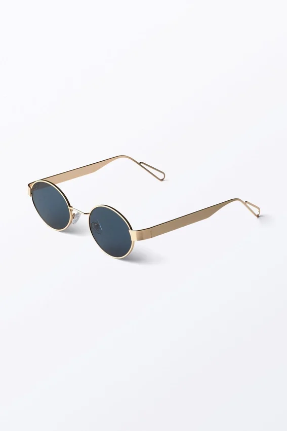 Gafas de sol ovaladas con montura metálica minimalista – Doradas – Lentes azul oscuro Gafas de sol ovaladas con montura metálica minimalista – Doradas – Lentes azul oscuro