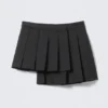 Minifalda cruzada plisada asimétrica – Negro Minifalda cruzada plisada asimétrica – Negro