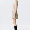 Minifalda plisada con tachuelas – Beige Minifalda plisada con tachuelas – Beige