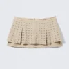 Minifalda plisada con tachuelas – Beige Minifalda plisada con tachuelas – Beige