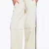 Pantalones de chándal de nailon con cremallera desmontable – Beige – Rayas negras Pantalones de chándal de nailon con cremallera desmontable – Beige – Rayas negras