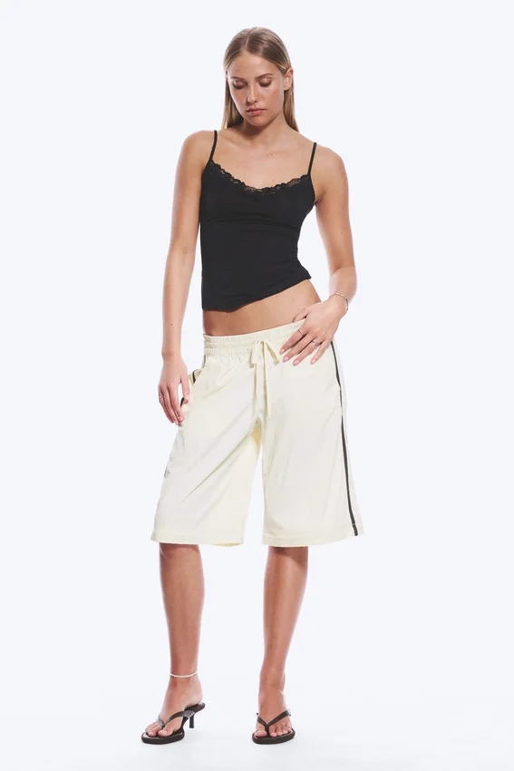Pantalones de chándal de nailon con cremallera desmontable – Beige – Rayas negras Pantalones de chándal de nailon con cremallera desmontable – Beige – Rayas negras