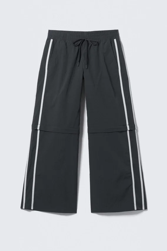 Pantalones de chándal de nailon con cremallera desmontable – Negro – Rayas beige Pantalones de chándal de nailon con cremallera desmontable – Negro – Rayas beige