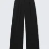 Pantalones de traje plisados de talle medio y corte holgado – Negro Pantalones de traje plisados de talle medio y corte holgado – Negro