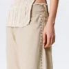 Pantalones holgados de talle bajo con tachuelas y corte acampanado – Beige Pantalones holgados de talle bajo con tachuelas y corte acampanado – Beige