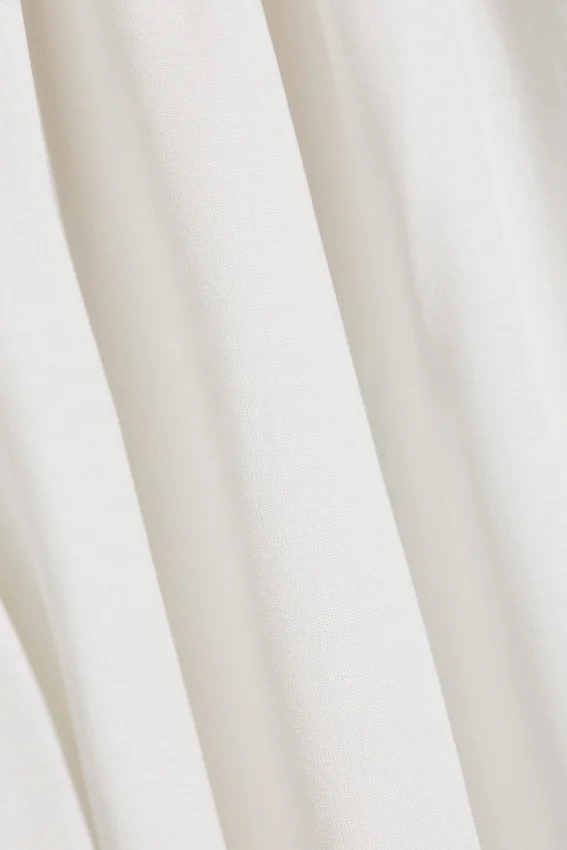 Pantalones holgados de talle medio y corte acampanado – Blanco Pantalones holgados de talle medio y corte acampanado – Blanco
