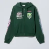 Sudadera con capucha y cremallera de corte recto y con estampados – Verde oscuro con estampados variados Sudadera con capucha y cremallera de corte recto y con estampados – Verde oscuro con estampados variados