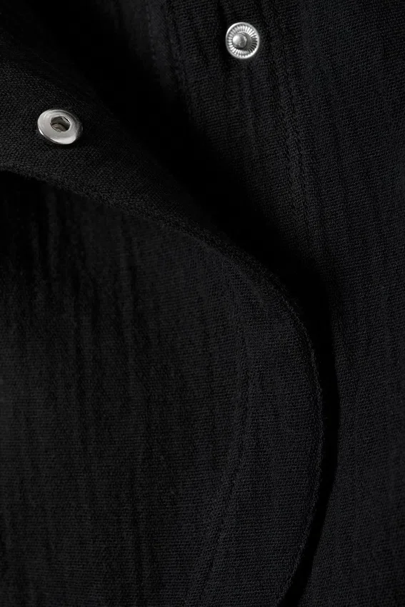 Top asimétrico sin mangas con volantes – Negro Top asimétrico sin mangas con volantes – Negro