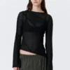 Top asimétrico transparente con cuello barco – Negro Top asimétrico transparente con cuello barco – Negro