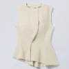 Top sin mangas con peplum asimétrico – Crudo Top sin mangas con peplum asimétrico – Crudo